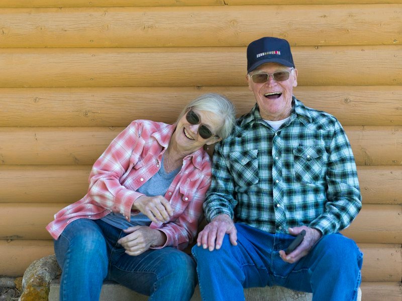 Elderly couple sitting together outdoors
